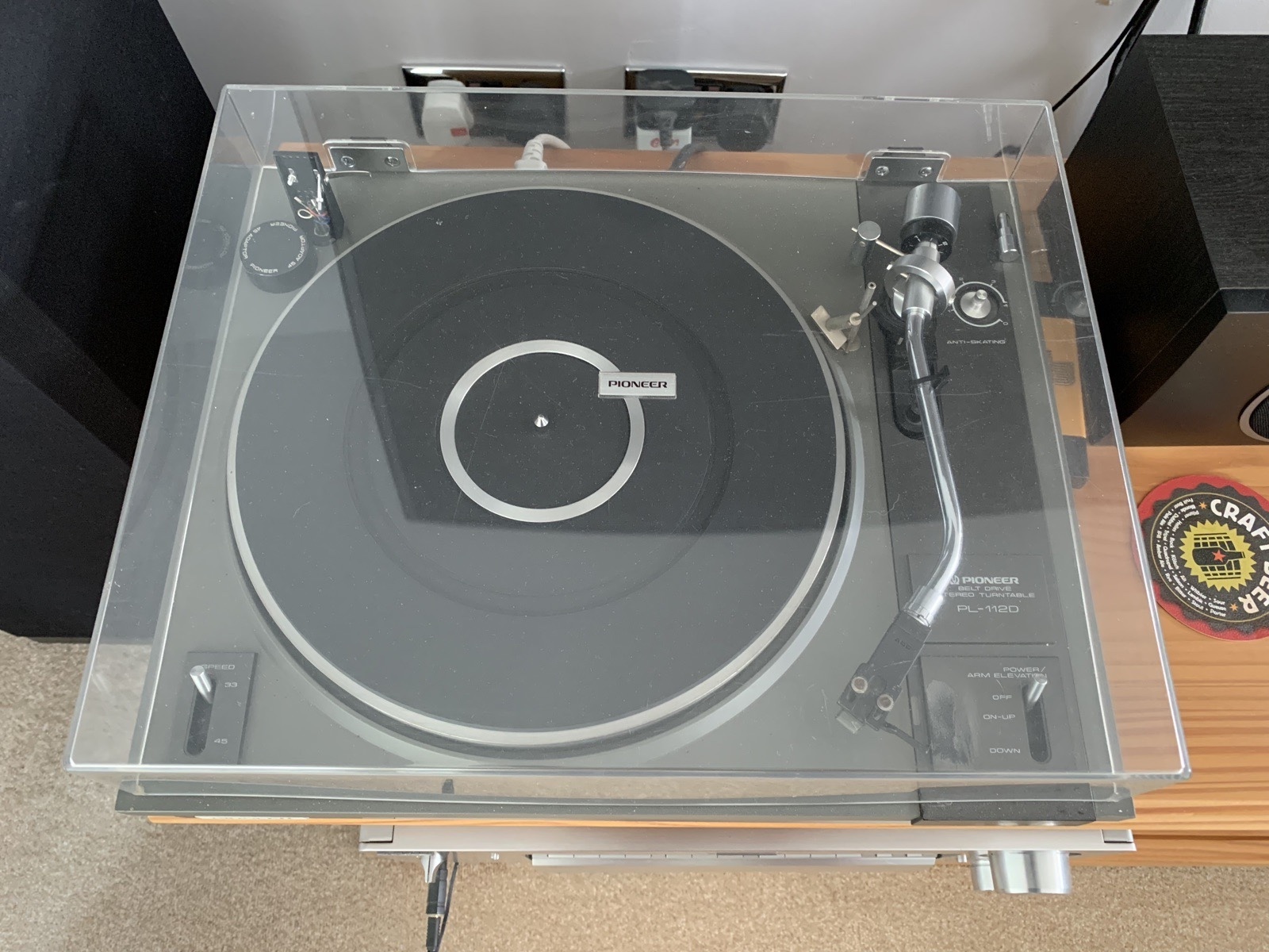 The Pioneer belt-drive turntable, seen from above through its dust cover