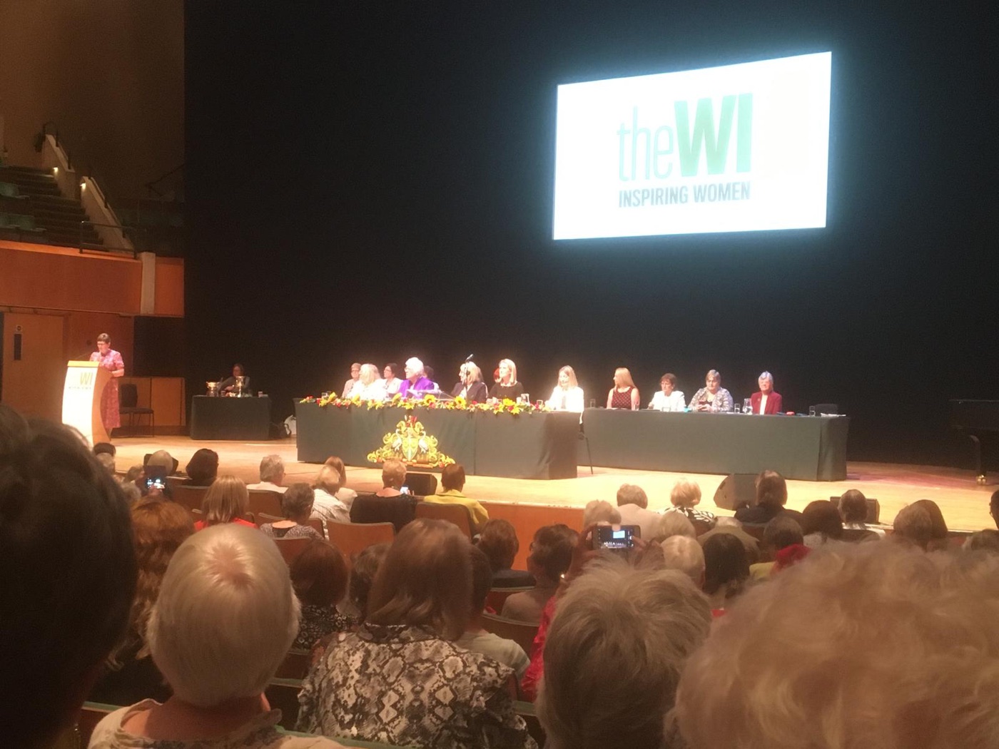 The WI National Annual Meeting in Cardiff — a full hall, with the top table on stage beneath the WI banner